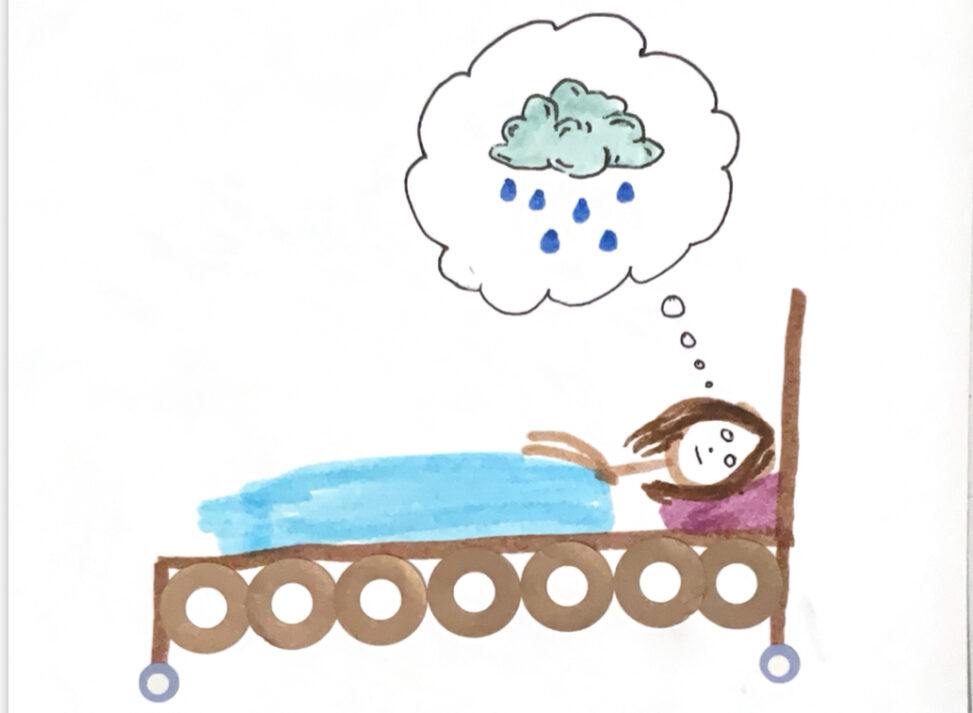 A girl is lying in bed. She is awake and has a thought bubble above her head with a cloud and rain inside it.
